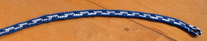7-loop braid, navy and white. Loop manipulation braiding/ fingerloop braiding